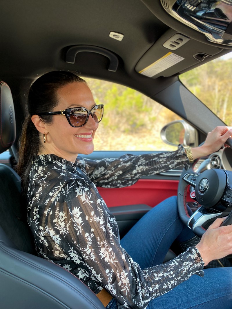 Image credit: Nicole Palumbo (Event Marketing for Alfa-Romeo) Christina-Lauren Pollack Test Driving an Alfa-Romeo at Monterey Car Week